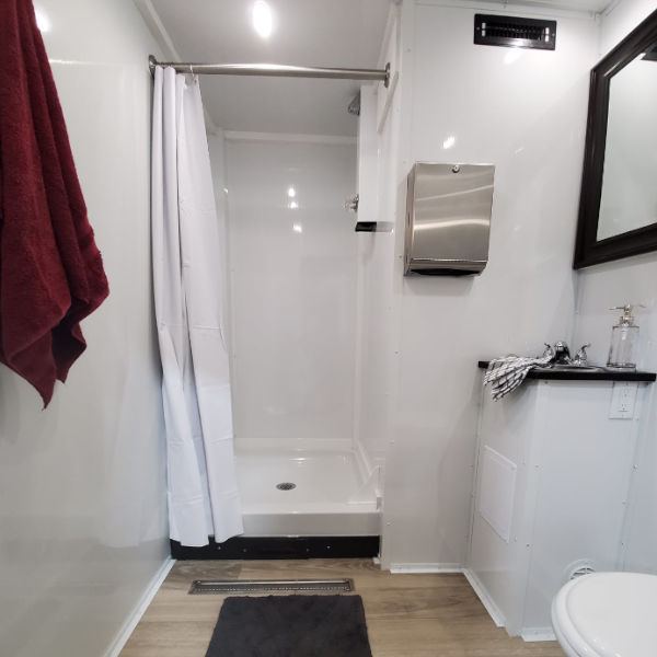 Shower room inside a restroom and shower combo trailer