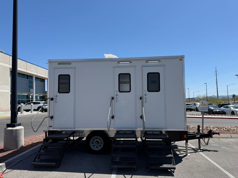 Three-room restroom trailer parked on a paved lot